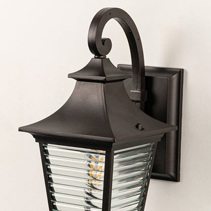 Closeup view of lantern wall light with ribbed glass detailing and matte black frame showing premium craftsmanship.