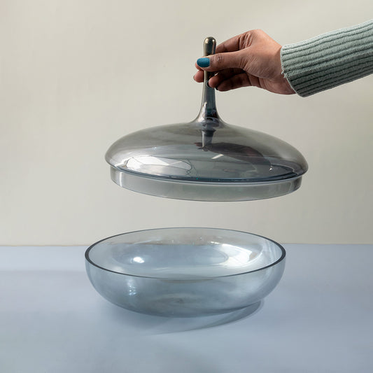 Clear glass decorative bowl with matching lid displayed for elegant tabletop styling and modern home decor.