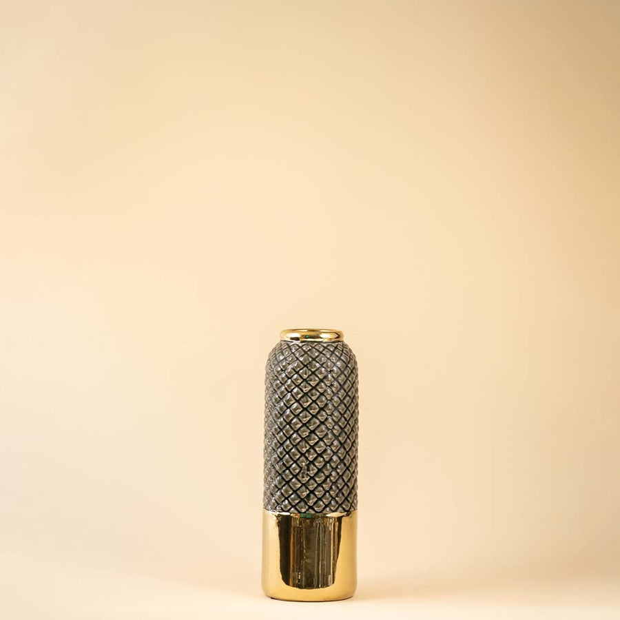 A tall grey and gold textured vase shown on a white background highlighting its glossy finish and modern geometric pattern in a clean bright setting.