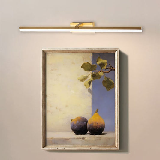 Closeup lifestyle view of gold metal picture light enhancing artwork with warm focused directional illumination.