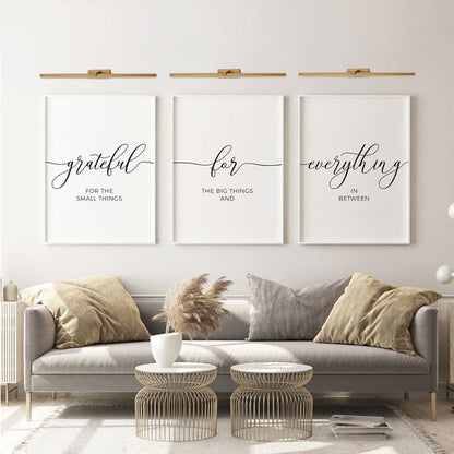 Gold metal picture lights styled together on a modern interior wall creating warm balanced gallery style accent lighting.