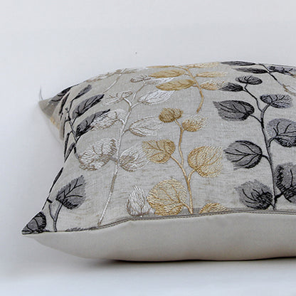 Closeup of cotton cushion embroidery showing intricate gold grey and black leaf stitching and soft textured fabric ideal for stylish home decor accents.