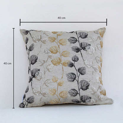 Cotton cushion with gold grey and black embroidered leaf pattern measured at 40 cm by 40 cm displayed on a white background showing its square design.