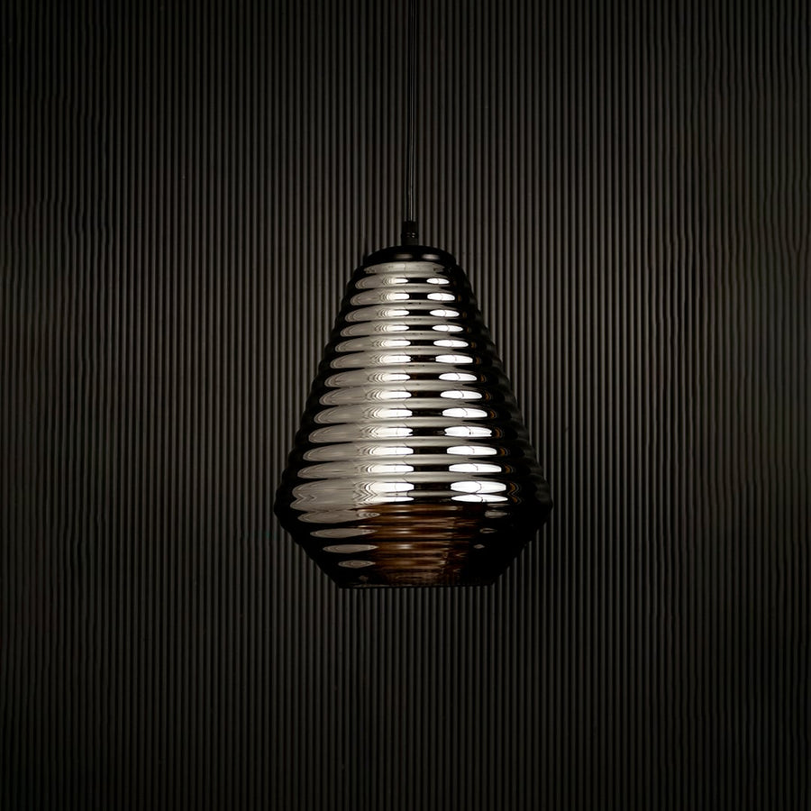 Smoked ribbed glass pendant light displayed on dark background with light off highlighting its elegant form and premium finish.