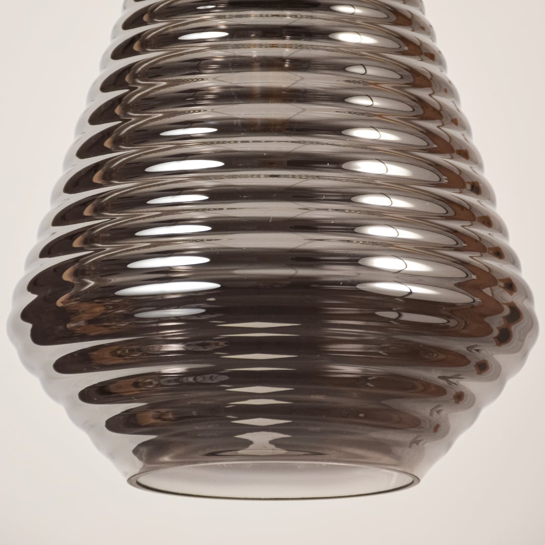 Close view of smoked glass pendant light showing ribbed detailing smooth surface and polished craftsmanship with modern elegance.