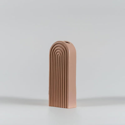 Tall peach ceramic vase with arched ribbed design displayed on a clean white surface  highlighting its modern minimal aesthetic.