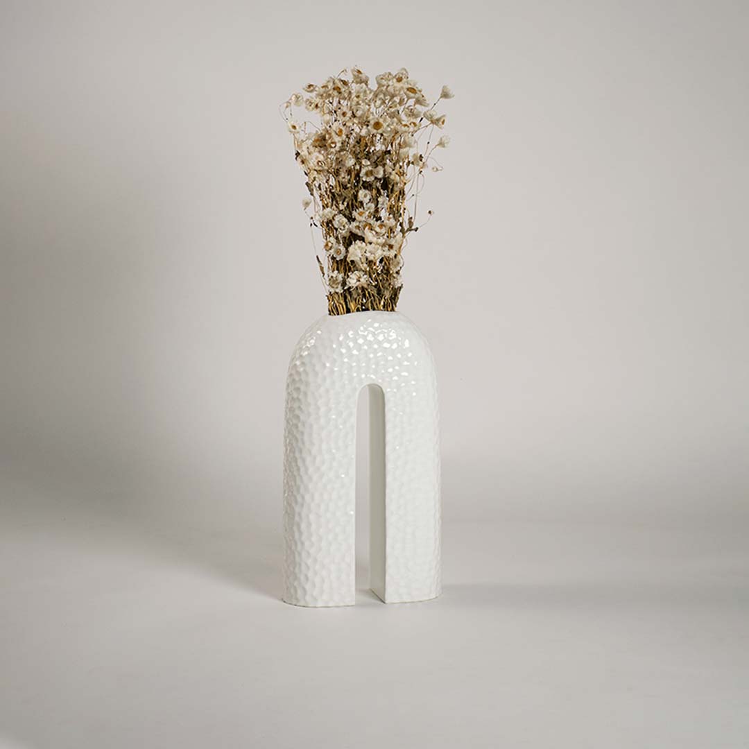 Contemporary ceramic vase styled in interior space bringing elegance and sculptural charm to the setting.