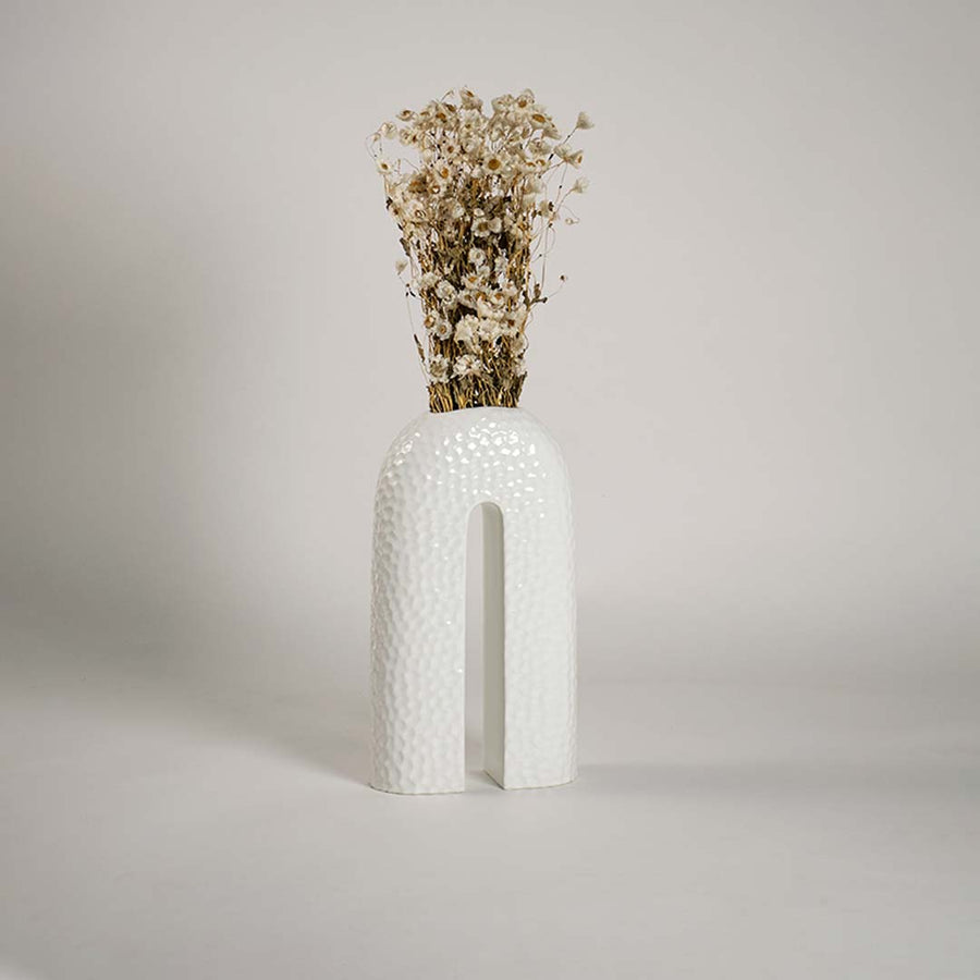 Contemporary ceramic vase styled in interior space bringing elegance and sculptural charm to the setting.