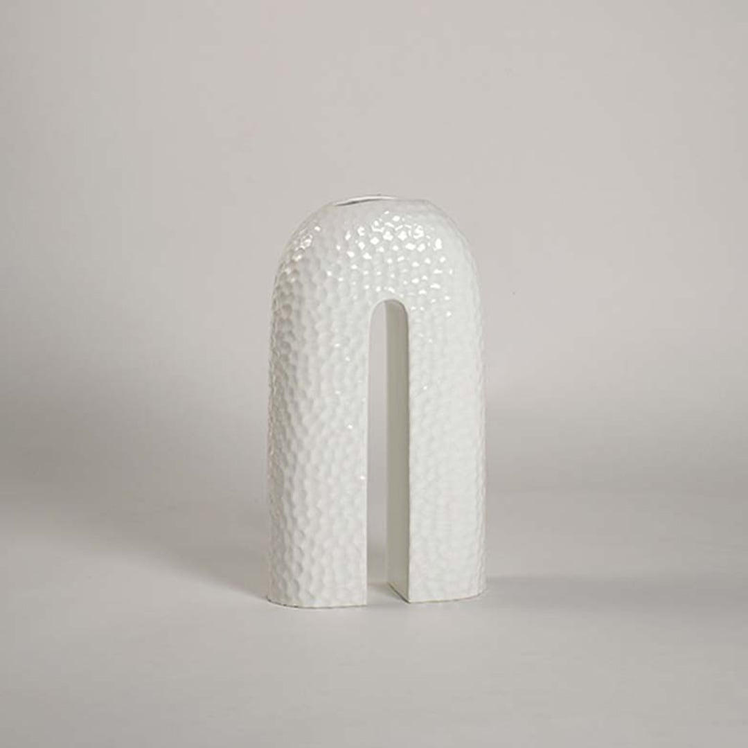 Elegant U-shaped ceramic vase in white finish displayed on plain white background with refined handcrafted texture.
