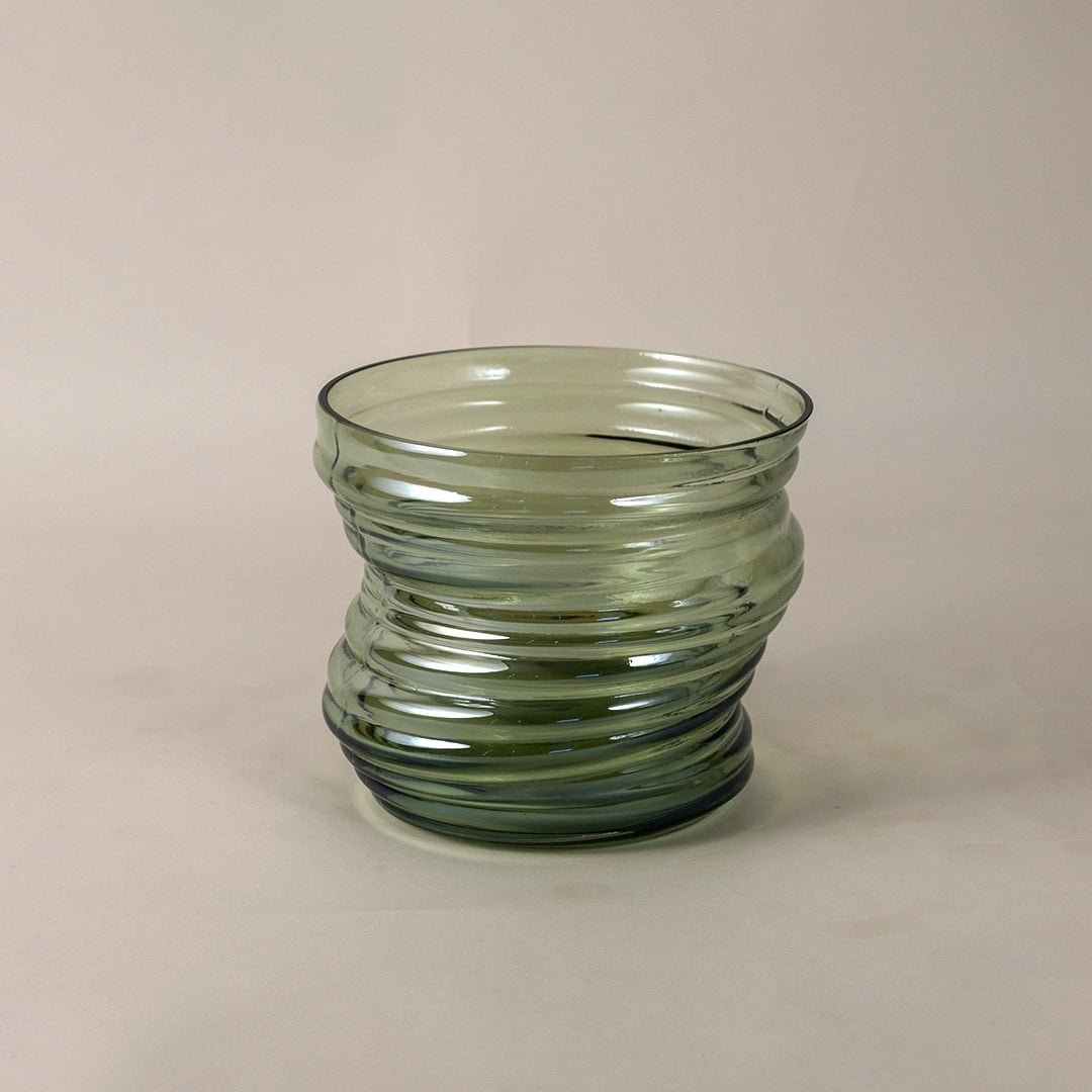 Textured green glass vase with curved pattern and modern style shown on white backdrop for detailed product view.