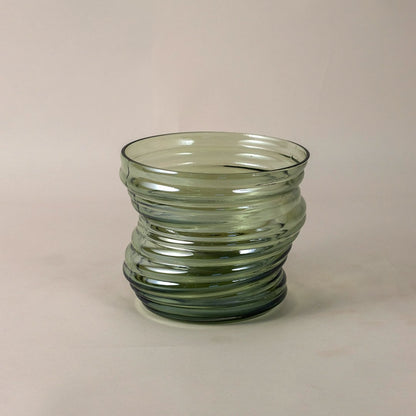 Textured green glass vase with curved pattern and modern style shown on white backdrop for detailed product view.