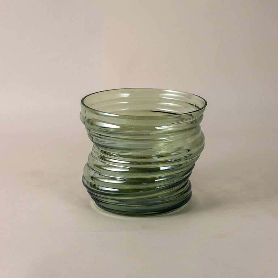 Textured green glass vase with curved pattern and modern style shown on white backdrop for detailed product view.