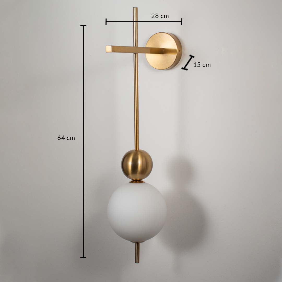 Wall lamp with white glass globe shade and gold base shown with size 64 cm height 28 cm width and 15 cm depth.