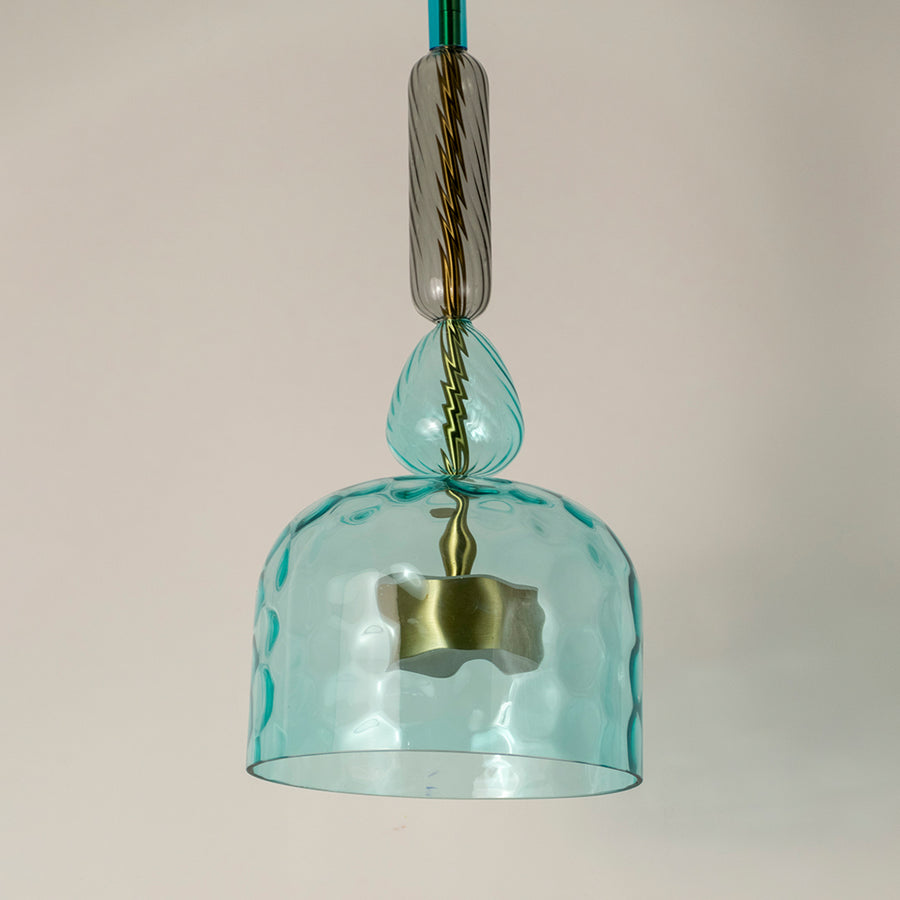 Closeup of turquoise textured glass pendant light with decorative details showcasing premium craftsmanship.