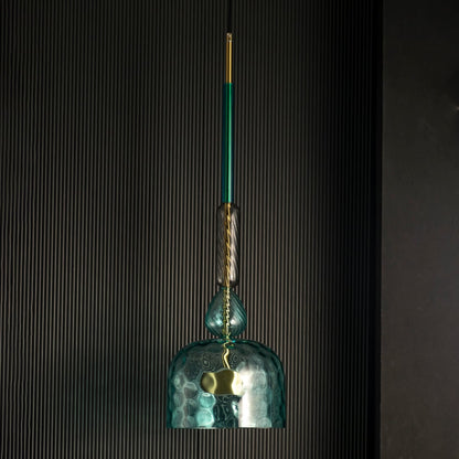 Rosetta teal glass pendant light off against a dark background highlighting its artistic glass texture.