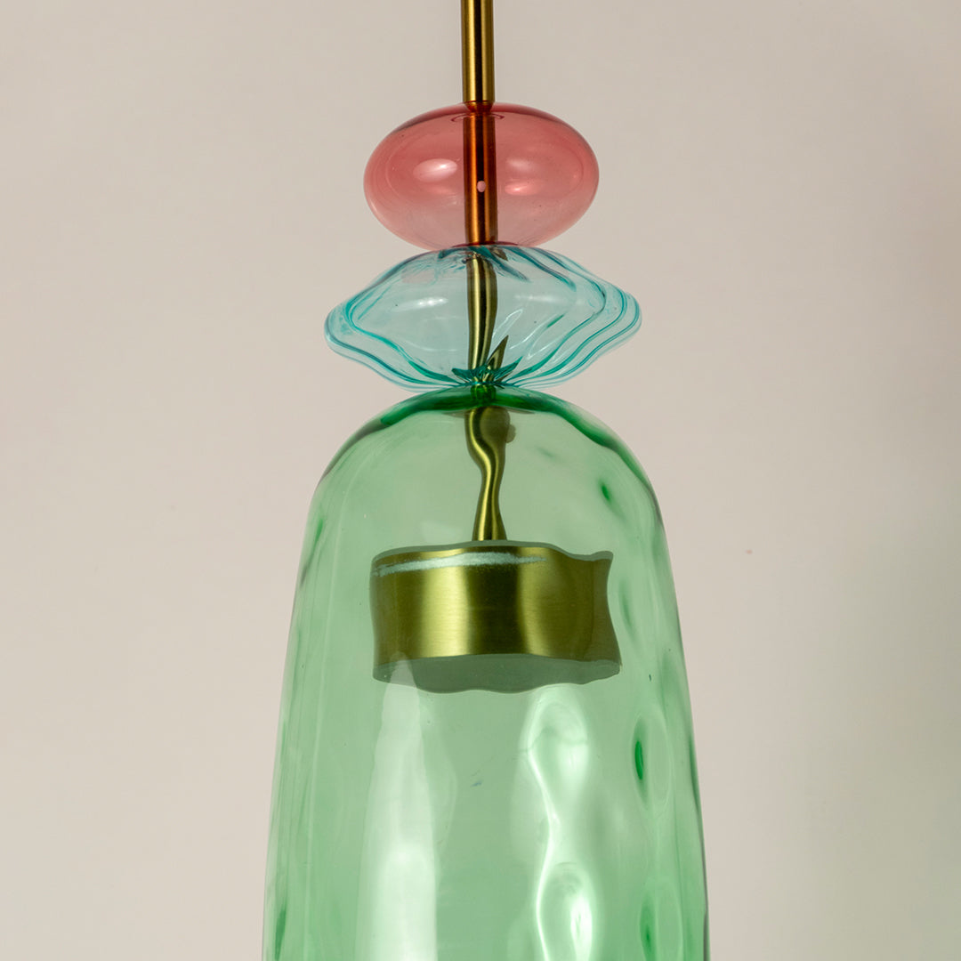 Closeup of mint green glass pendant light with coral accents showcasing artisan details and elegance.