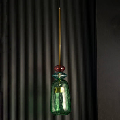 Rosetta green and pink glass pendant light off against a dark background emphasizing its sculptural glass texture.
