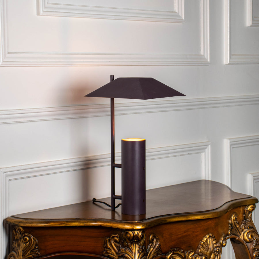 Modern brass desk lamp with geometric metal shade and sleek vertical base for luxury office and study decor.