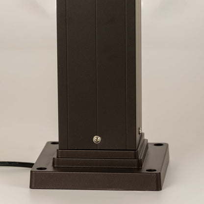 Closeup of black outdoor bollard light base with modern metal finish for elegant exterior decor use.