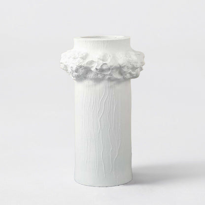 White ceramic decorative vase with floral sculpted rim for shelf styling and elegant modern home decor displays.