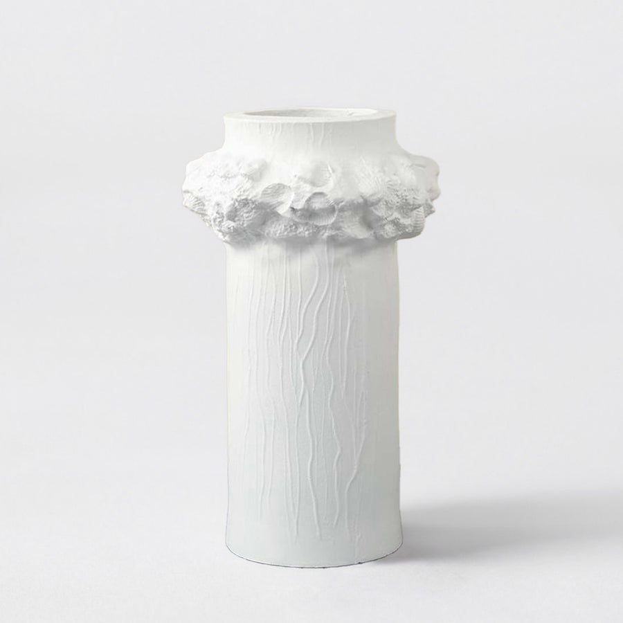 White ceramic decorative vase with floral sculpted rim for shelf styling and elegant modern home decor displays.
