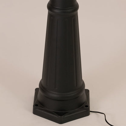 Detailed close up of black metal post lamp base showing textured pole construction decorative rings and foundation mounting design.