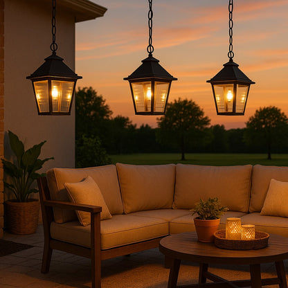 Traditional black metal hanging lantern with textured glass panels suspended from chain creating vintage outdoor porch lighting ambiance.