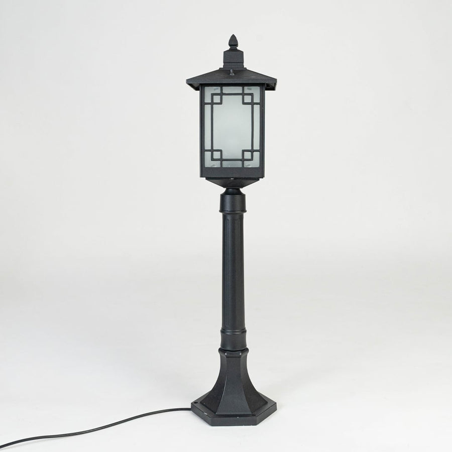 Black outdoor garden light with frosted glass panels for stylish exterior decor styling use.