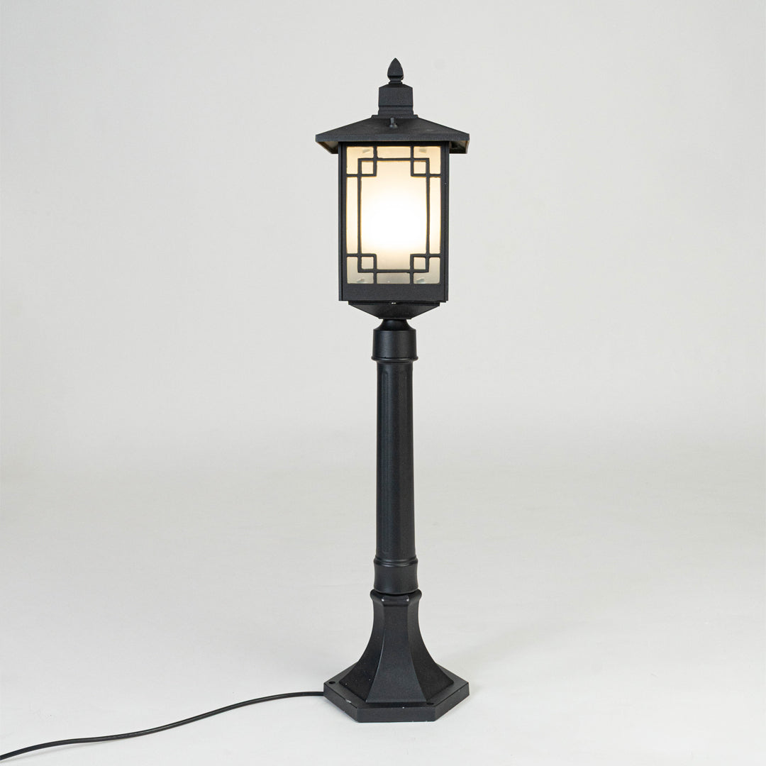 Vintage black outdoor garden light with warm glowing panels for elegant exterior decor styling use.