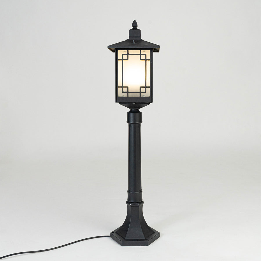 Vintage black outdoor garden light with warm glowing panels for elegant exterior decor styling use.