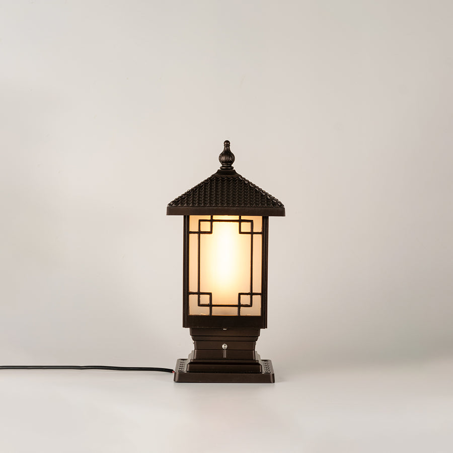 Vintage black outdoor gate light with warm ambient glow for luxury exterior decor styling use.