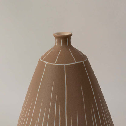 Brown ceramic decorative vase closeup showing etched vertical line texture and matte earthy finish for modern handcrafted decor styling.