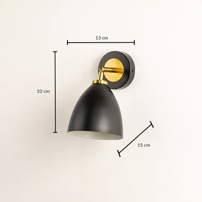 A black metal wall light measuring 22 cm height 15 cm depth and 13 cm width displayed against a soft beige wall highlighting its curved shade and adding modern interior décor.