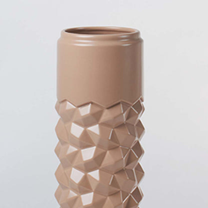 Close view of the tall beige ceramic vase showing its raised geometric texture and smooth glossy finish for a modern decor feel.