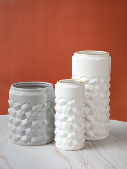 White textured ceramic vase arranged with complementary decor pieces creating a grouped display that adds a modern look to interiors.