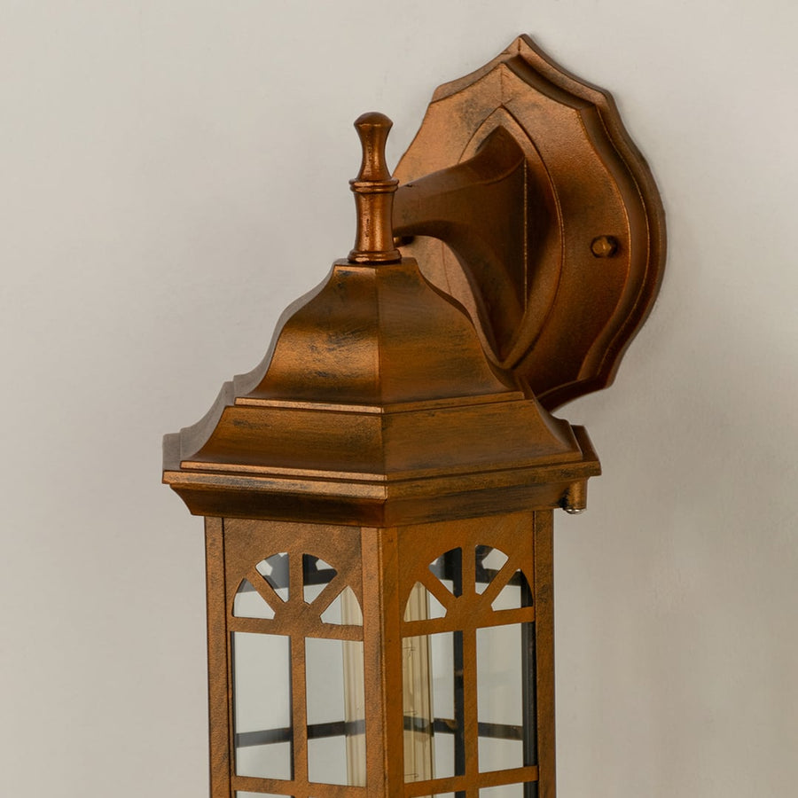 Closeup of the bronze outdoor lantern highlighting its arched glass panels antique bronze finish and detailed top design ideal for classic exterior decor.