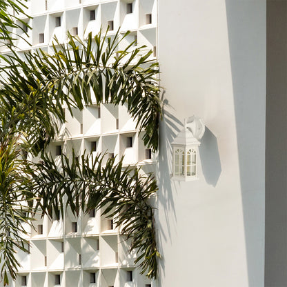 White outdoor lantern with the light off displayed on a clean exterior wall highlighting its classic window style glass panels and bright modern outdoor design.