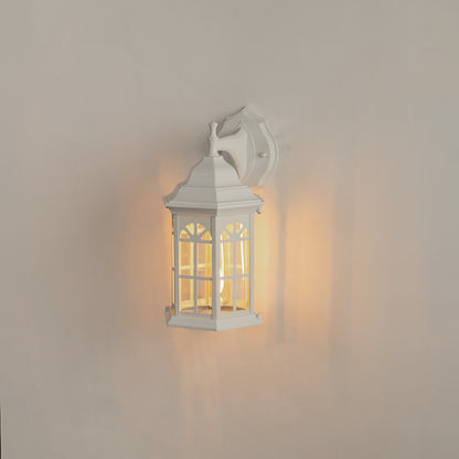 White aluminum outdoor wall lantern on white background with an arched paneled glass shade for vintage porch decor.