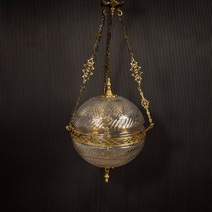 Gold metal hanging planter with glass bowl enhancing interiors with elegant vintage decor styling.