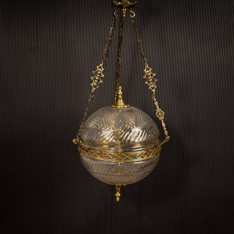 Gold metal hanging planter with glass bowl enhancing interiors with elegant vintage decor styling.