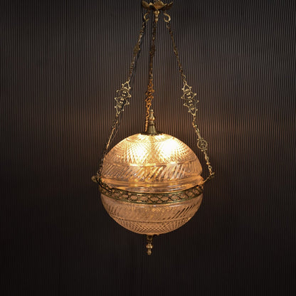 Gold metal hanging planter illuminated beautifully adding luxury charm to modern indoor spaces.