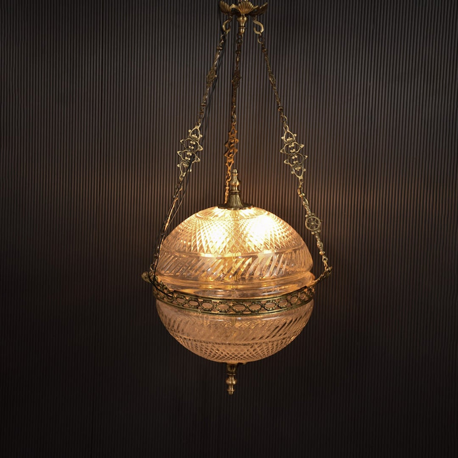 Gold metal hanging planter illuminated beautifully adding luxury charm to modern indoor spaces.