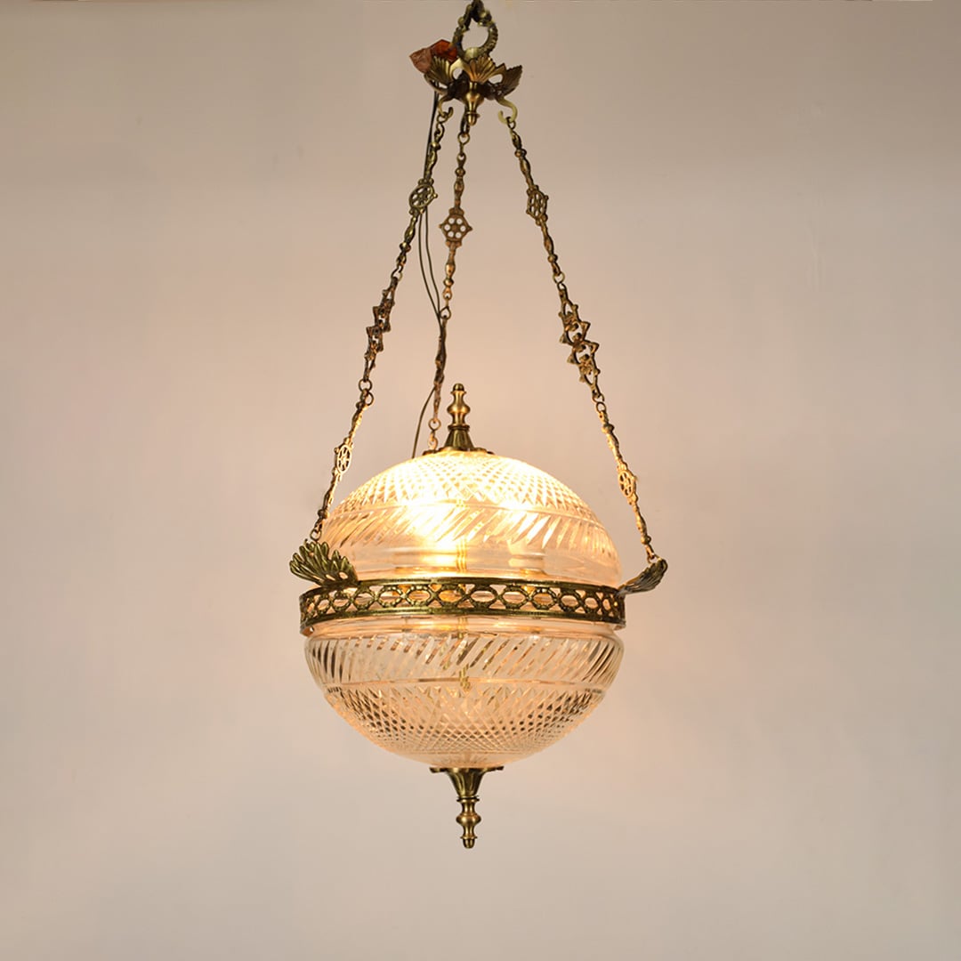 Gold metal hanging planter with decorative chain enhancing interiors with vintage inspired elegance.