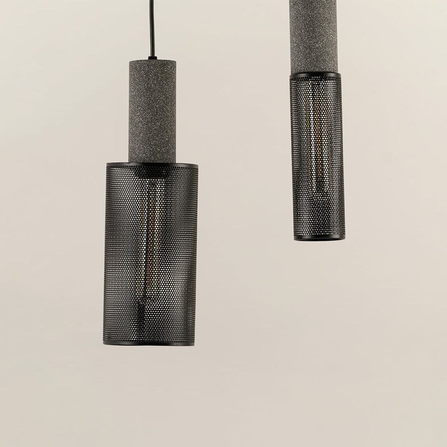 Multiple black mesh pendant ceiling lights arranged stylishly together adding modern industrial charm to home interior lighting.