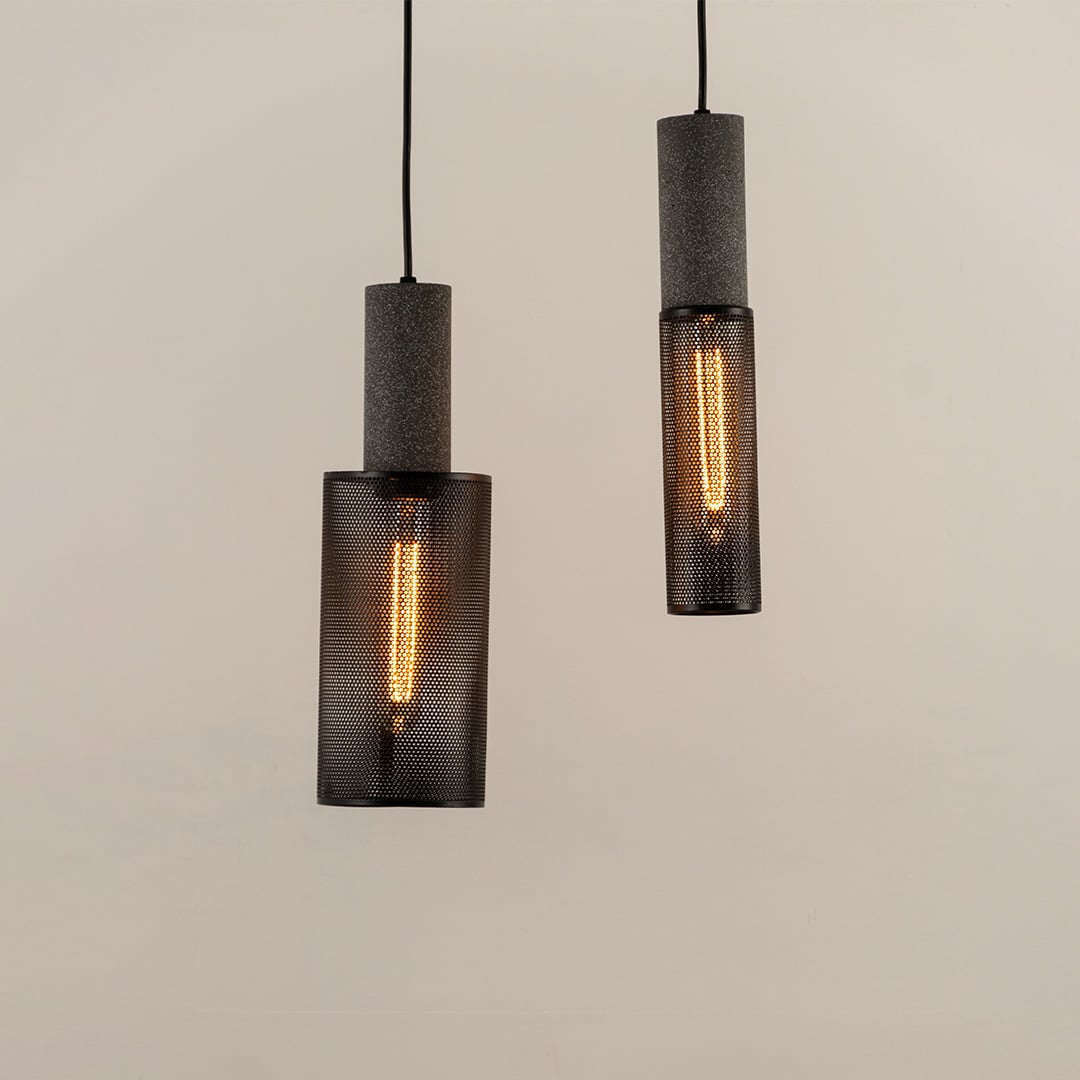 Set of black cylindrical mesh pendant ceiling lights displayed together creating modern industrial style lighting for interiors.