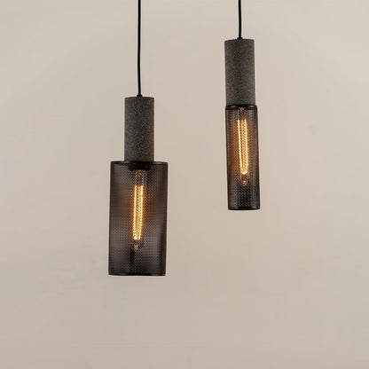 Set of black cylindrical mesh pendant ceiling lights displayed together creating modern industrial style lighting for interiors.