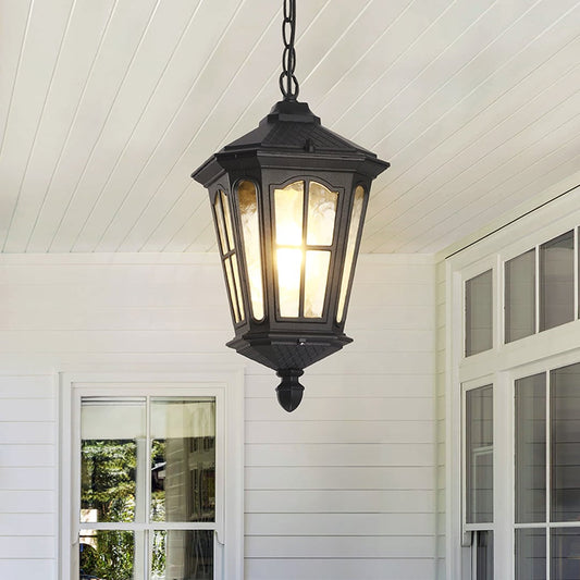 Vintage-style hanging lantern in a traditional outdoor dining area creates a welcoming and timeless exterior decor element.