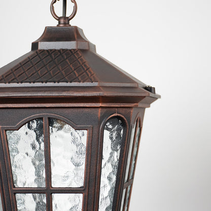 Close-up view of outdoor hanging lantern with textured glass and detailed metal frame showcasing its vintage design.