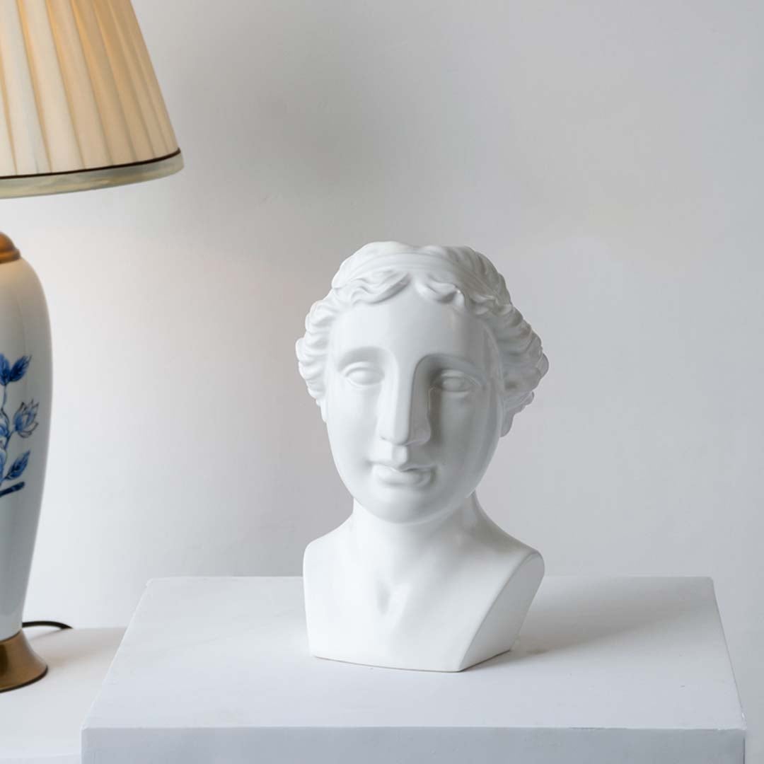White decorative bust displayed in bright natural light creating a refined artistic accent perfect for shelves consoles and statement spaces.