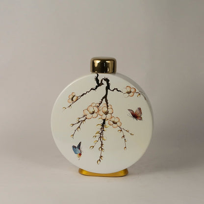 Round ceramic jar against white background emphasizing glossy finish and gold-topped lid.